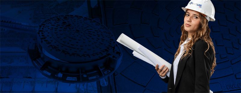 Engineer reviewing plans next to a manhole cover